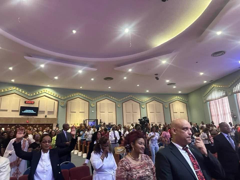 Participants gathered in a large indoor meeting room.